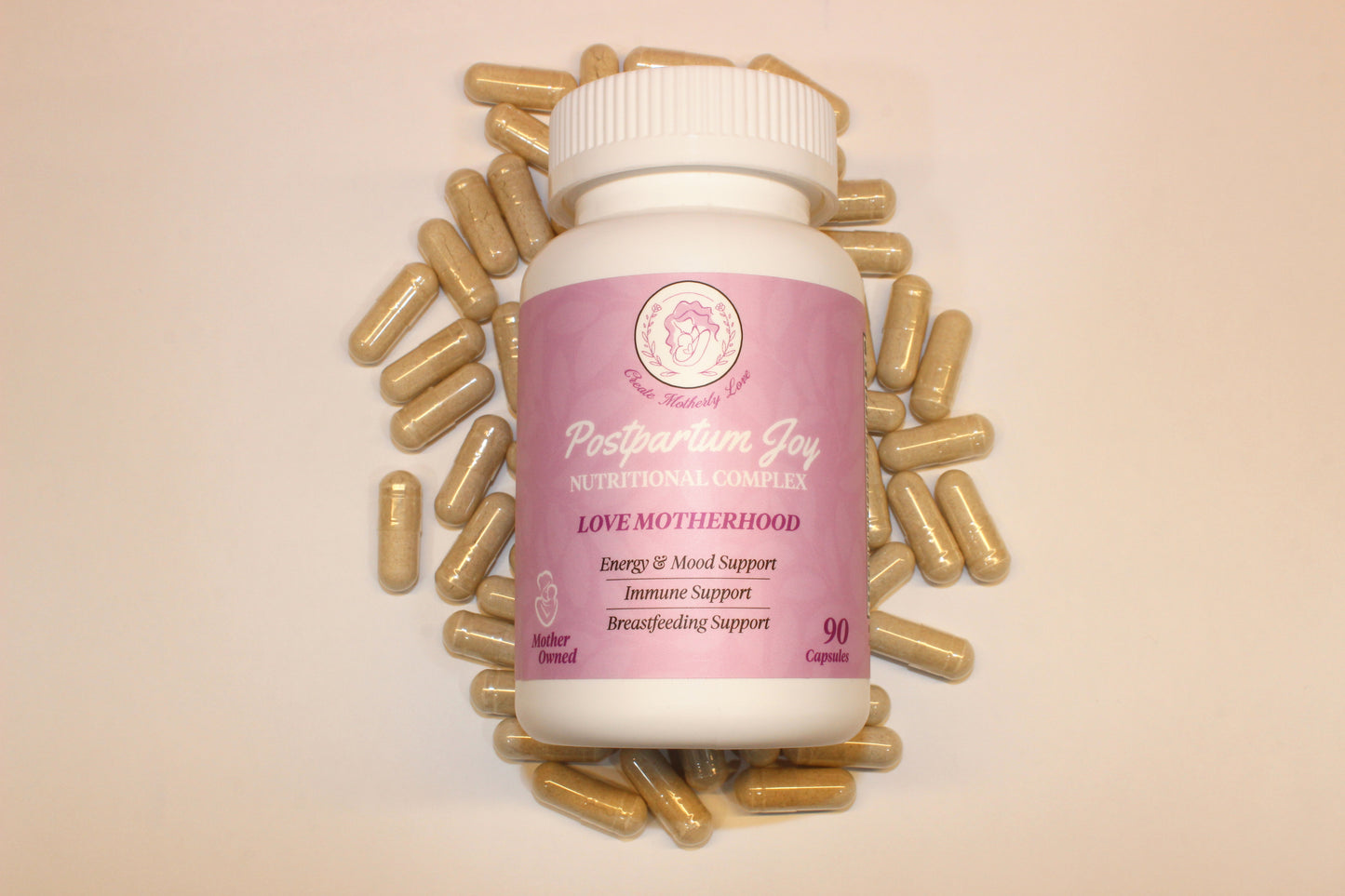 Supplement bottle labeled 'Postpartum Joy' surrounded by gold capsules on a beige background
