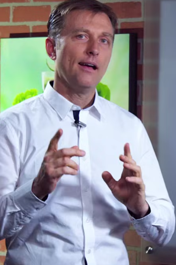 Dr Eric Berg explaining MTHFR genetics in front of a whiteboard with diagrams and text.